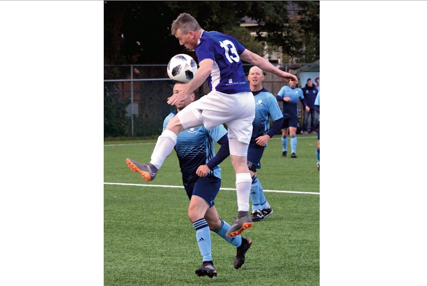 Dan Connolly of WPH Law (foreground) jumps for the ball Craig May of Feildians chases the play during a matchup between the two St. John’s entries at the Eastern Canadian masters soccer championship at King George V Park on Saturday. Feildians won the game 2-0, a result that guaranteed them a medal. They ended up with bronze. — Keith Gosse/The Telegram