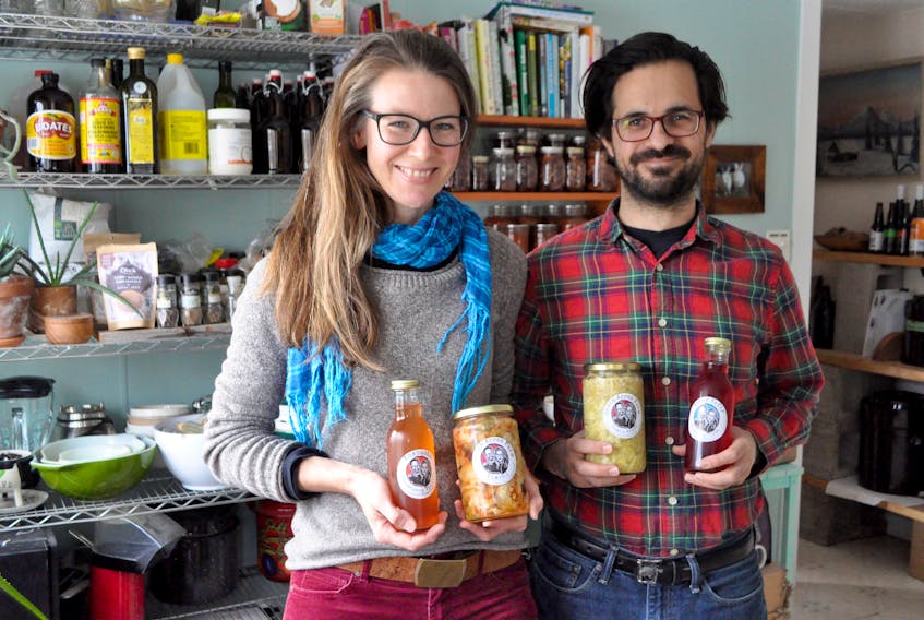 Seven Acres Farm owner Jocelyn Durston stands with her partner and fellow fermenter Chris Kasza with their fermented products in their kitchen, which doubles as their current work space. The duo is looking at expanding into a commercial kitchen as their business grows.