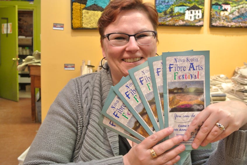 Denise Corey, chairwoman of the 11th Nova Scotia Fibre Arts Festival, looks over brochures for the 2018 show in October. The organizing committee is looking for volunteers to help with this year’s five-day festival.