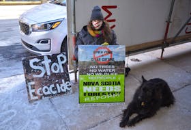 Jacob Fillmore and dog Muin hold an ongoing forestry clearcutting protest in front of One Government Place in downtown Halifax on Thursday, March 4.