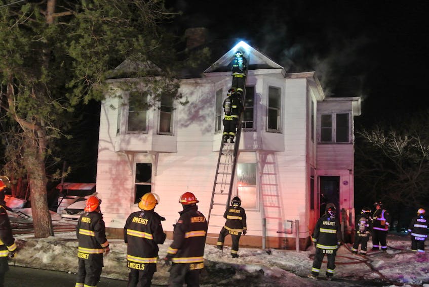 Amherst firefighters work to extinguish a fire at an Amherst apartment on Sunday night.