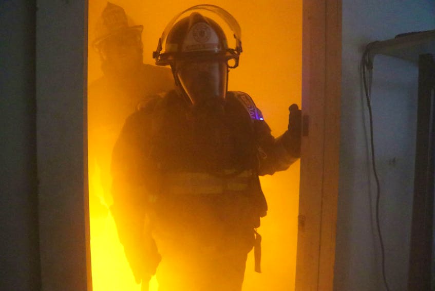 A firefighter with the Amherst Fire Department walks through a fire simulation created by the Bullex Attack System, which was recently purchased by the AFD.