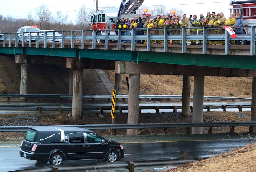 Cumberland County firefighters and other first responders stood atop the Exit 5 overpass near Springhill Saturday morning to pay their respect to Skyler Blackie, a firefighter with Truro Fire Services. Blackie passed away March 20.