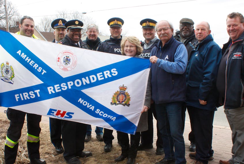 Representatives of the Amherst Fire Department, Amherst Police Department, Cumberland RCMP, and Emergency Health Services joined members of Amherst town council in raising a flag that recognizes the services first responders provide to the community.