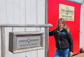 Shelby Gatti stands in front of the barn which houses her horses on the Nova Scotia Provincial Exhibition grounds. She is continuing to run her business on the grounds, while looking for a new location.