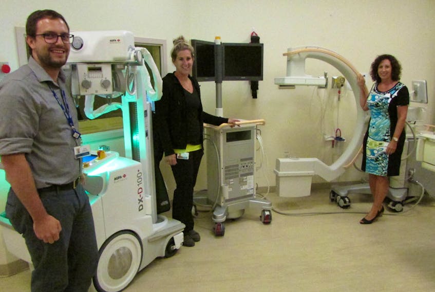 John Wright, diagnostic imaging and cardiac investigation unit manager at the Cumberland Regional Health Care Centre, looks over the new portable X-ray unit and C-Arm with diagnostic imaging team lead Megan MacLeod and Cumberland Health Care Foundation chair Katherine Hatheway.