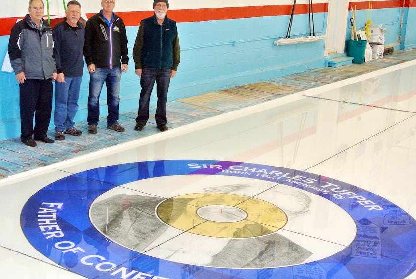 (From left) Wayne Bishop from the Cumberland County Museum, artist John Greer, Amherst Curling Club treasurer Robin Keith and senior curling co-ordinator Brian Trenholm look over one of the new house rings at the curling club.