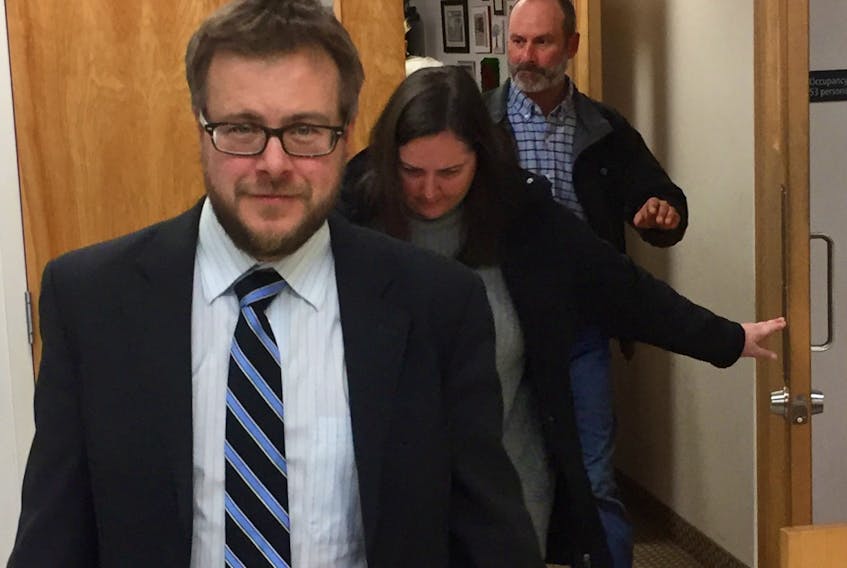 Lawyer Alex Embree leads client Meghan Leah MacAskill and her husband Daniel Marc MacAskill out of Dartmouth provincial court in January. The MacAskills, who pleaded guilty to defrauding their former employer of more than $109,000, have been given a three-year suspended sentence with probation.