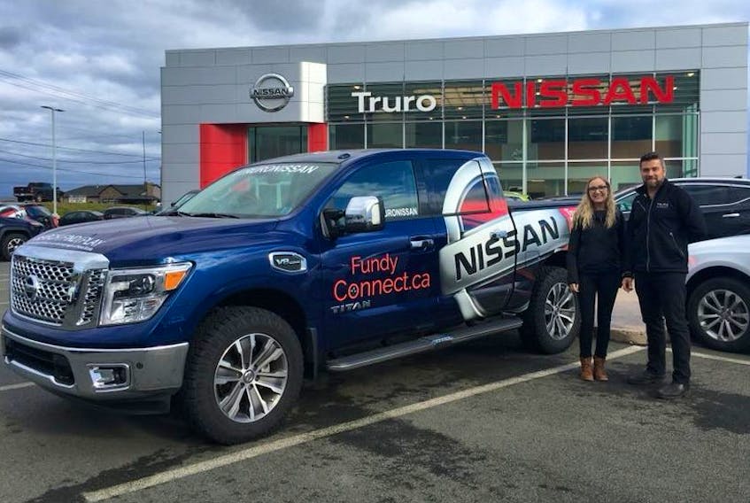 Truro Nissan General Manager, Erik Muckle, stands with Raven Knowles, the Fundy Connect Ambassador, and the vehicle which will be making its way across the region to promote the new web space spotlighting local events, www.fundyconnect.ca.