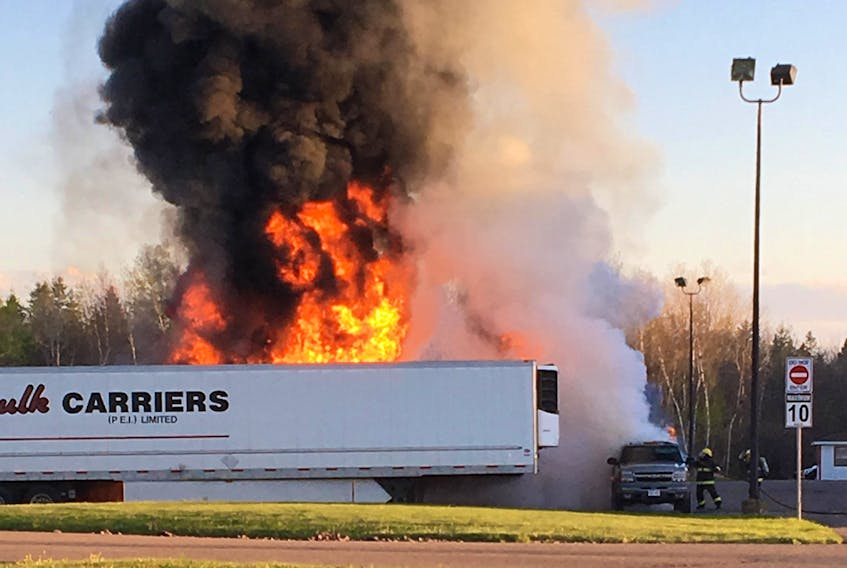 Flames and smoke can be seen coming from a trailer on fire in the GFS Foods parking lot on Monday. The fire is under investigation. Kurtis Langille photo
