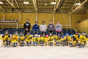 Gio Akeson, left, and other volunteers have stepped up in Antigonish to provide young athletes with an opportunity to play sledge hockey.