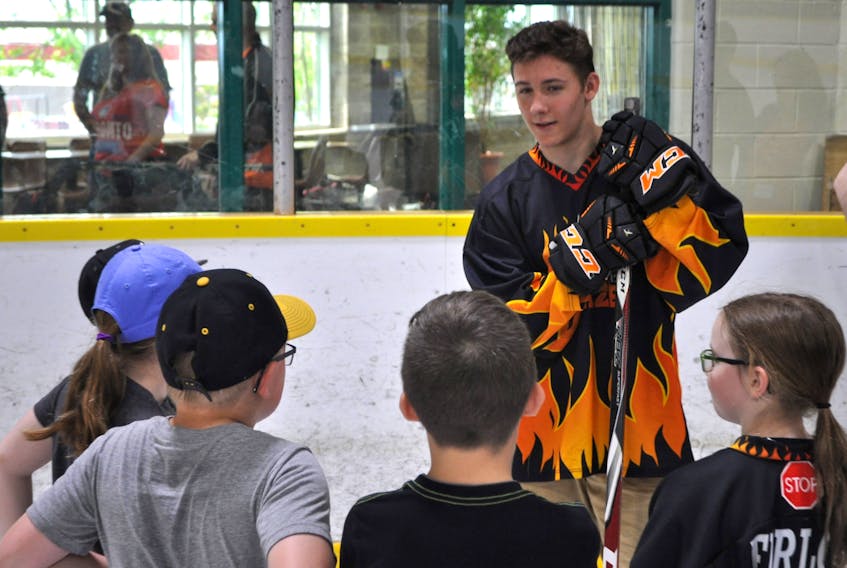 Alex Drover spent quality time with some young fans during a recent visit to Port aux Basques. - J.R. Roy