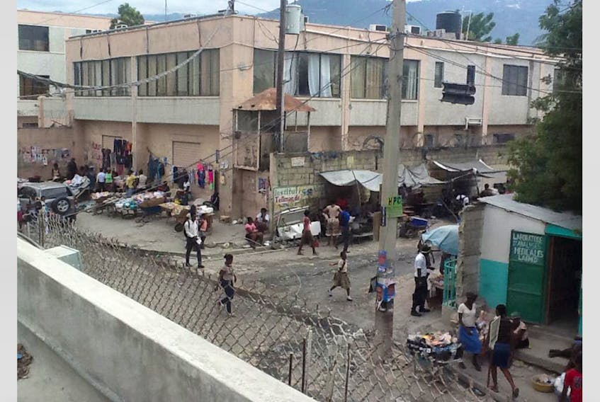 Just outside the wall of the medical compound lies a juxtaposition of everyday life in Haiti.