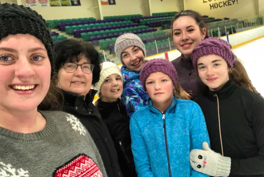 Front, Mandi Harvey and Ashleigh Ingram wear the headbands coach Maxine Connolly knit for them as Christmas gifts; back, from left, Natalie Kettle, Connolly, Gina Carroll, Leah Leamon and Brooklyn Neil.