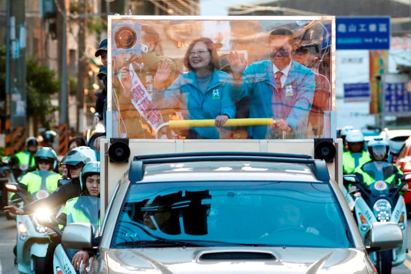 Taiwan’s President Tsai Ing-wen waves to the crowd during a parade in Taiwan, Thursday, The country goes to the polls today. - Reuters

