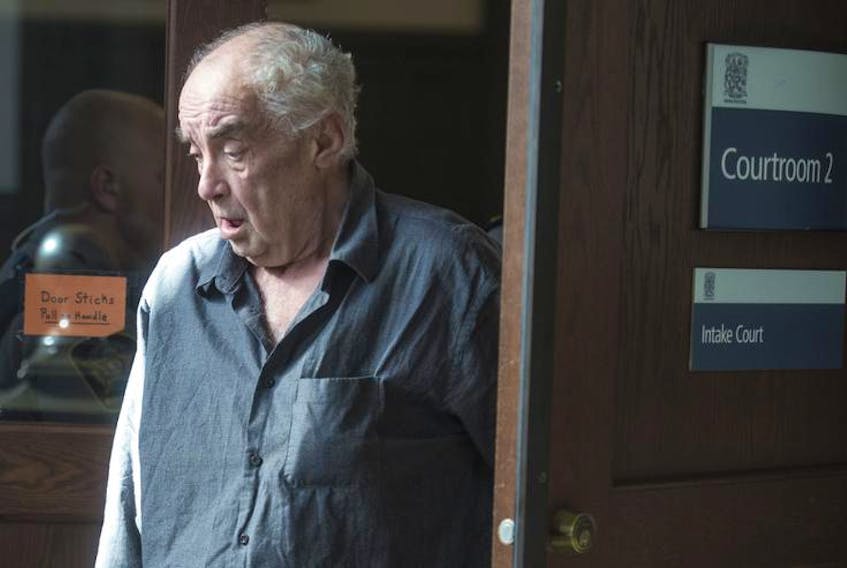 Robert Leo White, 70, is led out of Halifax provincial court Tuesday after appearing on charges of robbing a bank. The judge ordered a 30-day psychiatric assessment for White. Ryan Taplin - The Chronicle Herald