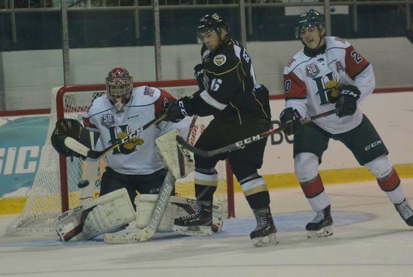 Halifax Mooseheads defenceman Justin Barron, right, and goalie Alexis Gravel keep an eye on Charlottetown Islanders forward Keith Getson during Saturday’s QMJHL game in Charlottetown.