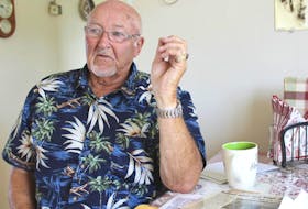 Bobbie Green sits at his kitchen table next to newspaper clippings about the 1973 mining explosion in Glace Bay. Green was one of six men injured in the flash fire.