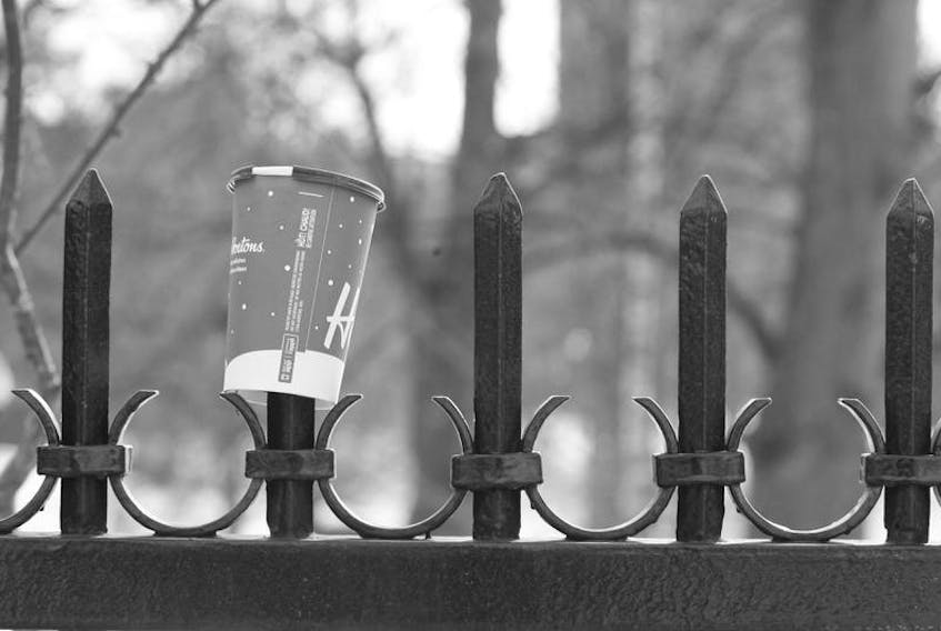 A Tim Horton’s cup is impaled on the wrought iron fence in this file shot of the Halifax Public Gardens on Sackville Street. - ERIC WYNNE/Chronicle Herald