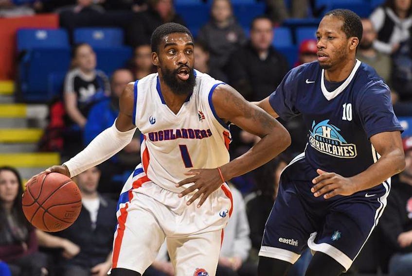 Cape Breton Highlanders guard Bruce Massey, left, tries to dribble around Halifax Hurricanes forward Mike Poole during NBL of Canada action. The Highlanders announced Massey will return to their lineup this season while the Hurricanes agreed to terms with Poole for his third season with the team.