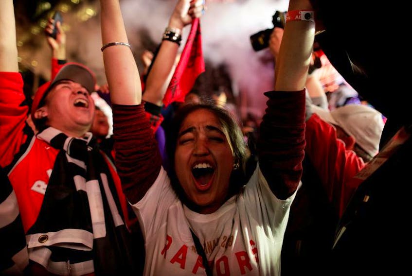 Fans celebrate after the Toronto Raptors defeated the Golden State Warriors in Oakland, California in Game Six of the best-of-seven NBA Finals, in Toronto on Friday, June 14, 2019. - Andrew Ryan / Reuters