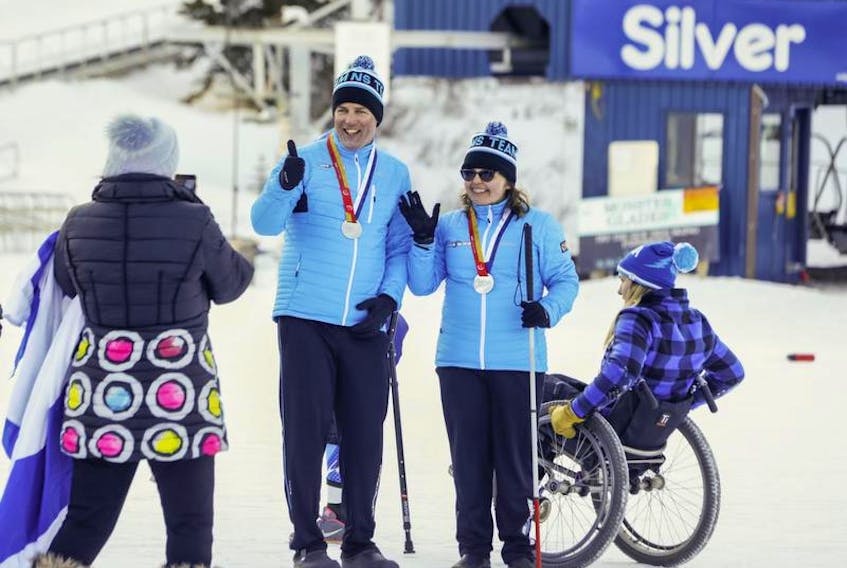 Brenda MacDonald, right, and her father Stephen, who was her guide, pose for a photo after winning the silver medal in the para giant slalom at the Canada Winter Games on Tuesday.