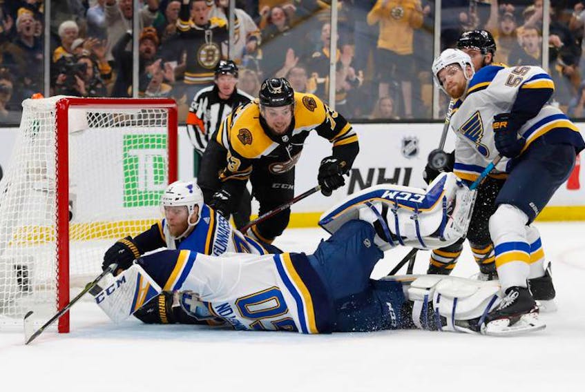 St. Louis Blues goaltender Jordan Binnington (50) and defenceman Carl Gunnarsson (4) collide as defenceman Colton Parayko (55) and Boston Bruins defenceman Charlie McAvoy (73) watch the puck bounce away during the third period in game five of the 2019 Stanley Cup Final at TD Garden on Thursday, June 6, 2019. - Winslow Townson / USA TODAY Sports