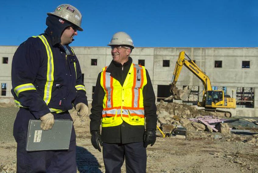Heritage Gas president John Hawkins (right) talks with construction supervisor Ryan Boudreau at a work site in Dartmouth.