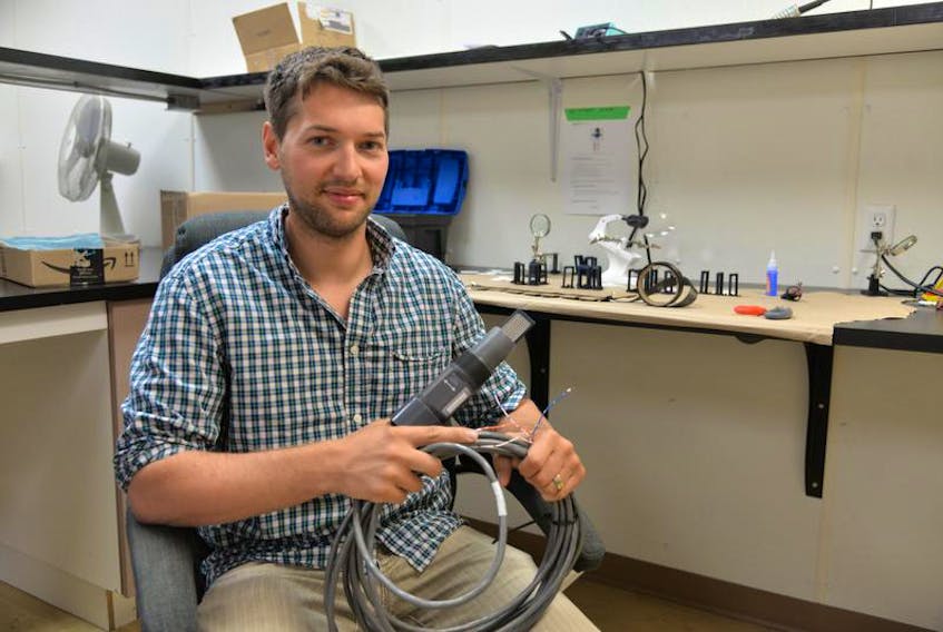 Colin Ragush of Island Water Technologies in Charlottetown, holds one of the bio-electrode sensors the company is installing in wastewater facilities across Canada.