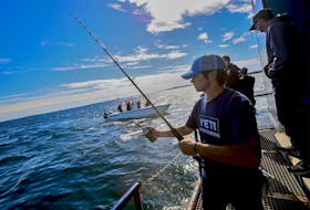 Christian Purcell and other crew members on the MV Ocearch prepare with the crew aboard the Contender as they fish for a great white shark off Eastern Points, Saturday September 22, 2018. No great white sharks were caught on this day.