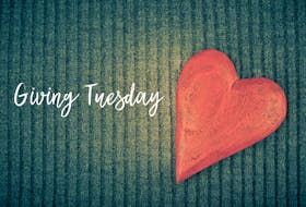 Stock Photo - Giving Tuesday is a global day of charitable giving after Black Friday shopping day. Charity, give help, donations and support concept with text message sign and red wooden heart