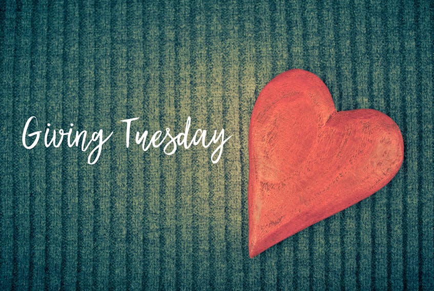 Stock Photo - Giving Tuesday is a global day of charitable giving after Black Friday shopping day. Charity, give help, donations and support concept with text message sign and red wooden heart