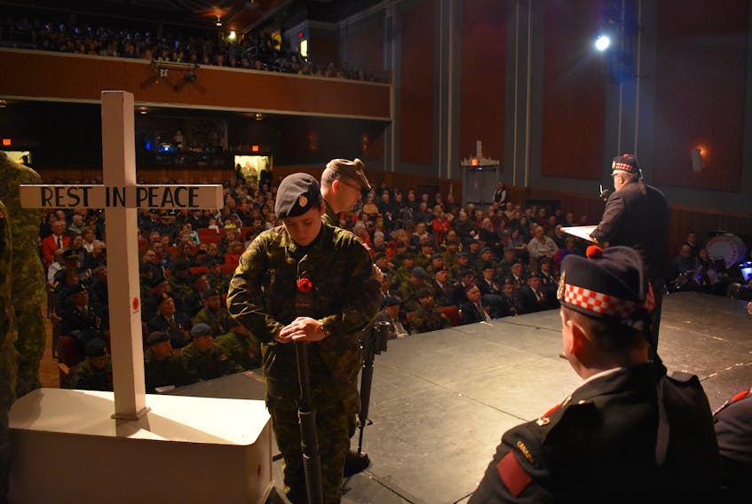 Private Bethany Snow stands, while the MC of the Glace Bay Remembrance Day Ceremonies, John Kennedy speaks at the Savoy Theatre on Saturday.