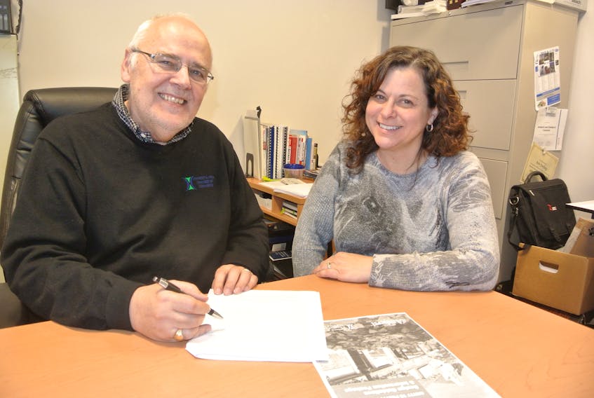Amherst and Area Chamber of Commerce executive director Ron Furlong and Amherst’s business development officer Rebecca Taylor look over plans for the Gritty to Pretty program being introduced for commercial properties in Amherst.