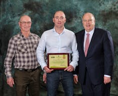 Greg McKenna, left, son Gordon McKenna, with Robert Irving. Gordon was recently recognized for his efforts in sustainable potato farming by Cavendish Farms.
