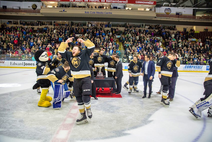 Newfoundland Growlers forward Scott Pooley celebrates after he and his teammates finished posing with the E.A. “Bud” Gingher Trophy after winning the ECHL Eastern Conference final with a 3-0 win over the Florida Everblades Saturday night at Mile One Centre.