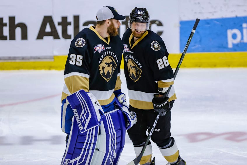 Newfoundland Growlers backup goalie Eamon McAdam (35) congratulates Josh Kestner after Kestner had scored the game-winning goal in overtime against the Toledo Walleye Saturday night at Mile One Centre. The win gave the Growlers a 1-0 lead over the Walleye in the best-of-seven ECHL final. — Newfoundland Growlers photo/Jeff Parsons