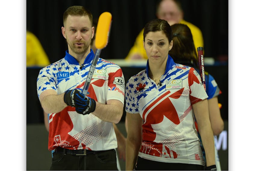 Brad Gushue and Lisa Weagle discuss a shot during their mixed double games on Thursday, the opening day of the Continental Cup of Curling in Las Vegas. — Curling Canada photo/Michael Burns