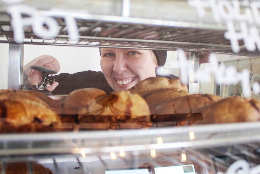 Sarah Benneto O’Brien, owner of the Handpie Company, chooses a handpie for a customer. MILLICENT MCKAY/JOURNAL PIONEER