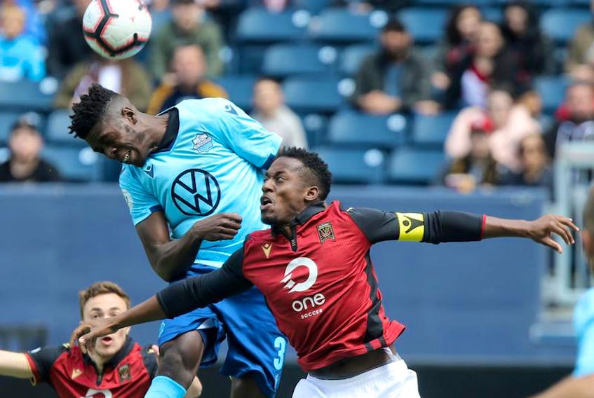 HFX Wanderers FC’s Andre Bona, left, wins a battle for a header over Valour FC’s Jordan Murrell during CPL action in Winnipeg on May 11.