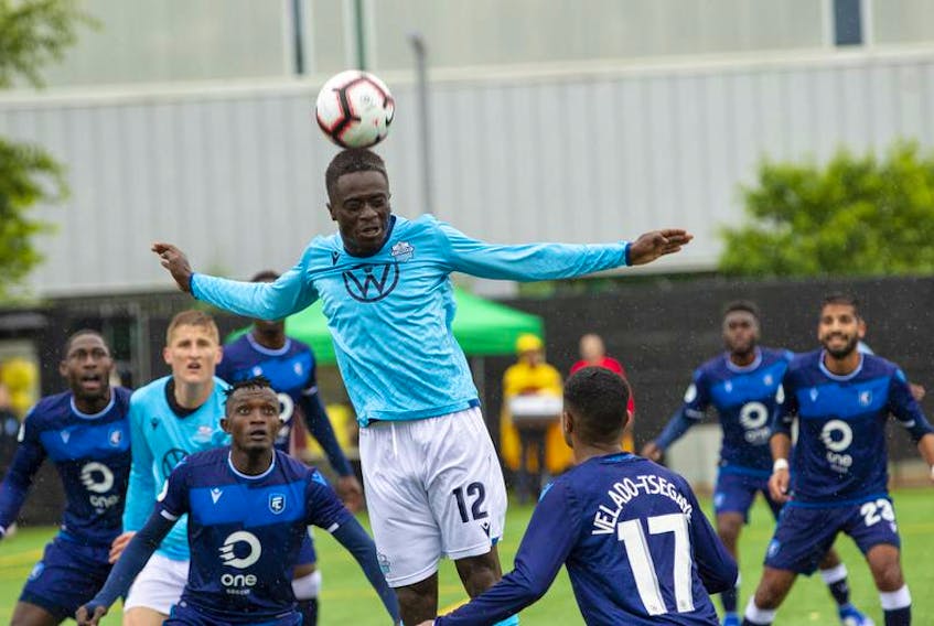HFX Wanderers FC’s Kourouma Mohamed soars above FC Edmonton players during a Canadian Premier League game on Monday at Clarke Stadium in Edmonton.