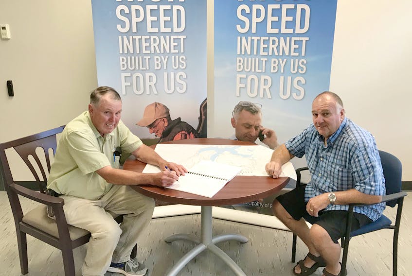 Municipality of Pictou County Warden Robert Parker, left, and Deputy Warden Wayne Murray sign a contract with Nova Communications, a division of ROCK Networks, to begin the engineering planning and network construction of phase one of the Municipality’s rural internet project.