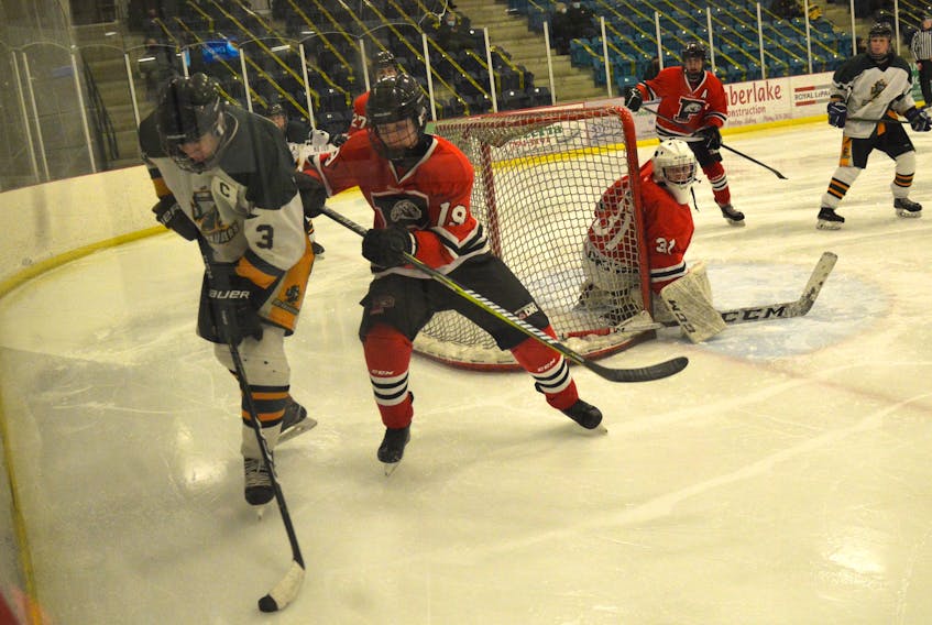 Will Lawless of the Memorial Marauders, left, protects the puck as he's pressured by Khoner White of the Glace Bay Panthers during Cape Breton High School Hockey League playoff action at the Emera Centre Northside on Thursday. Glace Bay won the game 8-1.