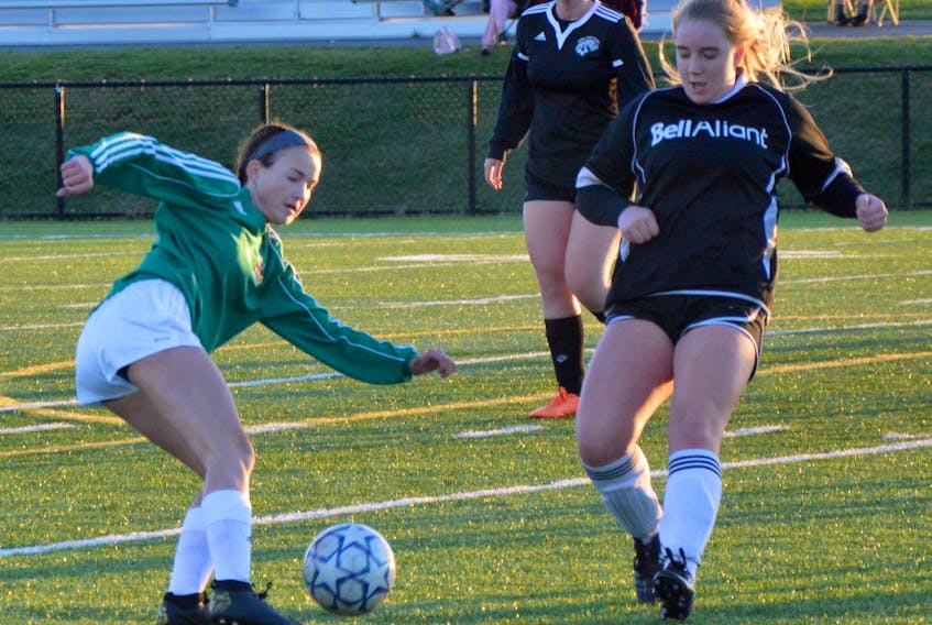 Olivia Sweeney of the Breton Education Centre Bears, left, works her way around Morgan O'Keefe of the Glace Bay Panthers during Cape Breton High School Soccer League action at Open Hearth Park in Sydney on Friday. BEC won the game 4-0.