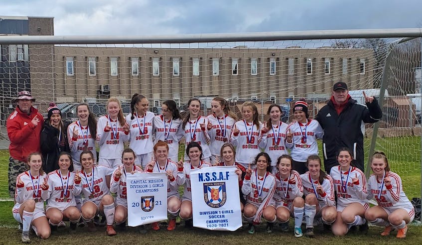The Halifax West Warriors celebrate their second NSSAF Division 1 girls' soccer banner in three years after blanking the Cobequid Cougars 2-0 in the provincial final Saturday afternoon in Truro.  ANDREW MacRAE / Contributed