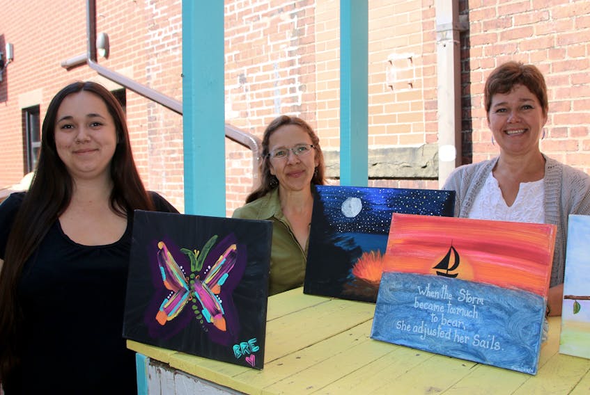 Heal Your Heart Through Art will continue to run this year, thanks to funding from the County of Colchester and 100 Women Who Care. Some of those involved in Heal Your Heart Through Art are, from left, Breanna Muise, painting participant; Lisa Cochrane, support counsellor at Third Place Transition House; and Jackie Waugh, who leads the program.