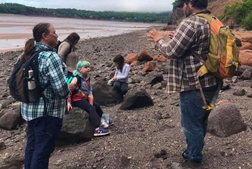 Brian Hebert leads a tour on the beach at Joggins. Hebert and his wife, Laura Thompson, were looking forward to another big year for Fundy Treasures Gifts and Tours until COVID-19 spun the tourism industry on its head.