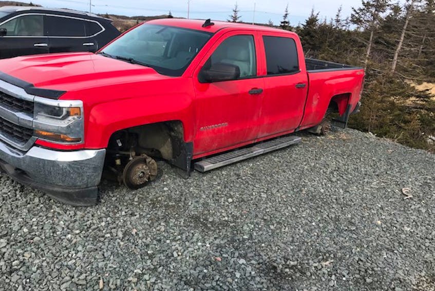 Tires and rims were stolen from this red Chevrolet truck while parked in car pool area on Holyrood Access Road on April 19, 2019.