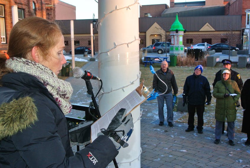 Allison Lair of the Empowering Beyond Barriers society addresses the crowd during a homeless memorial ceremony at Victoria Square in Amherst on Dec. 21.