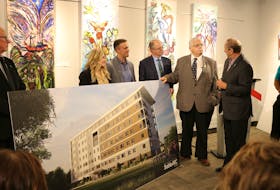 Arnold Croken, left, Tina Mundy, former minister of human and family services, Dave Arsenault of Arsenault Bros. Construction, Minister of Social Development and Housing for P.E.I. Ernie Hudson, Summerside Mayor Basil Stewart and MP for Egmont Bobby Morrissey view the concept art for the 70-unit apartment complex that is being built in downtown Summerside.